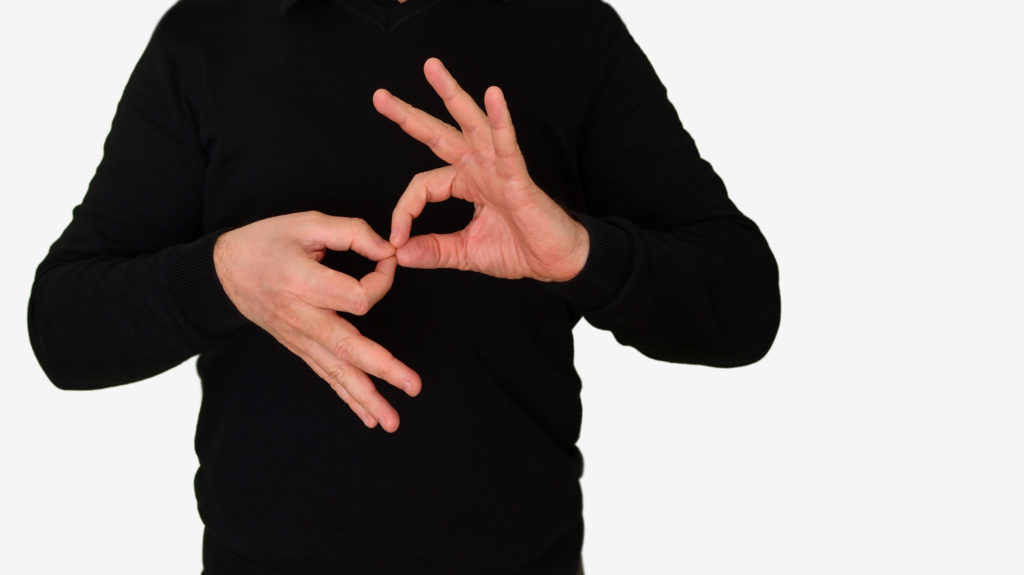 A person making an x with their hands